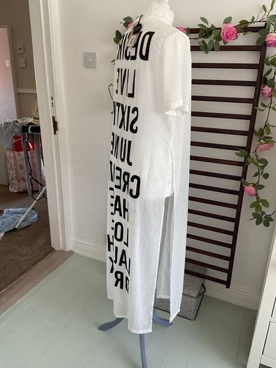long tunic with side slits Bnwt.  Short sleeve white with black logo