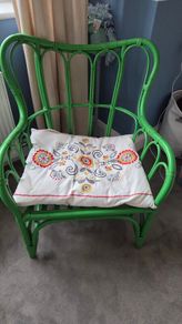 green rattan chair and cushion