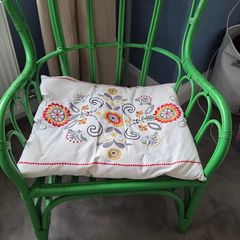 green rattan chair and cushion