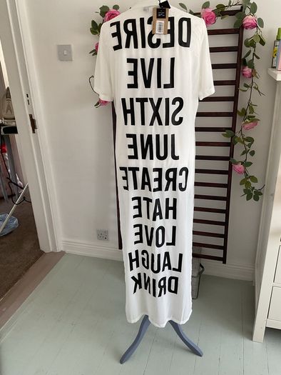 long tunic with side slits Bnwt.  Short sleeve white with black logo