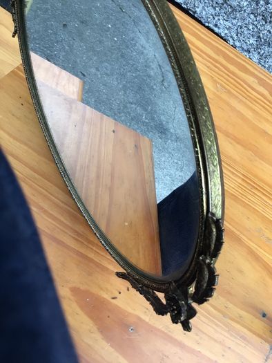 Brass framed ornate oval mirror