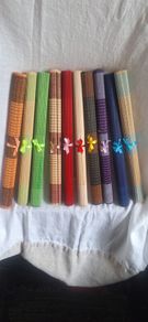 Ten Multicoloured woven bamboo placemats.