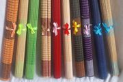 Ten Multicoloured woven bamboo placemats.