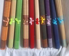 Ten Multicoloured woven bamboo placemats.