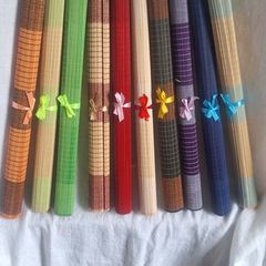 Ten Multicoloured woven bamboo placemats.