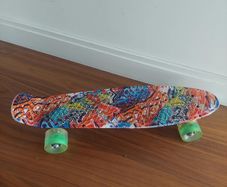 Graphic print penny board skateboard with green wheels