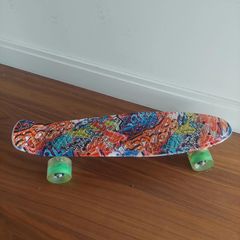 Graphic print penny board skateboard with green wheels