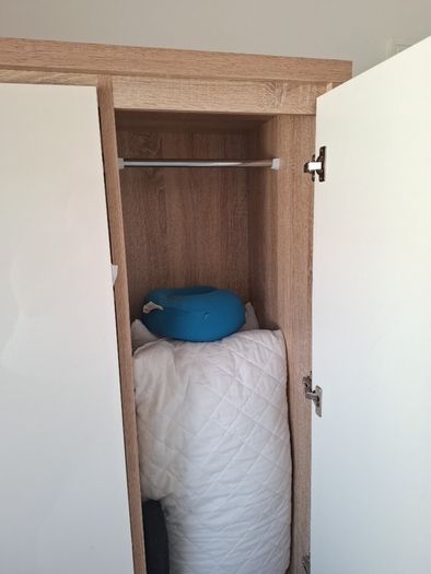 Timer and white wardrobe and bedside locker