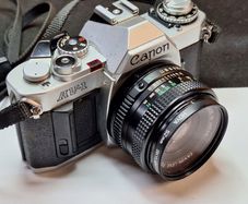 Canon AV-1 35mm SLR Film Camera with Canon FD 50mm f1.8 Lens & Hoya Filter (Pre-owned, SilverBlack)
