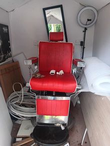 Beautiful red vintage Barbers chair with white piping