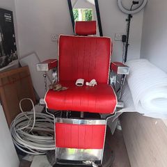 Beautiful red vintage Barbers chair with white piping