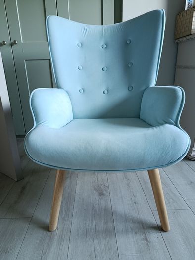 Light blue button-back armchair