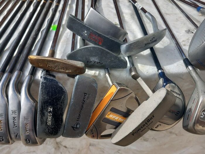 A selection of Golf clubs. Bags and golf balls.