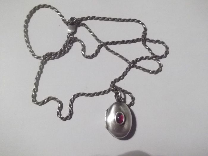 a silver locket with a silver chain
