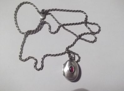 a silver locket with a silver chain