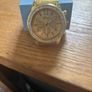 Gold coloured watch with diamonds around the face Image 2