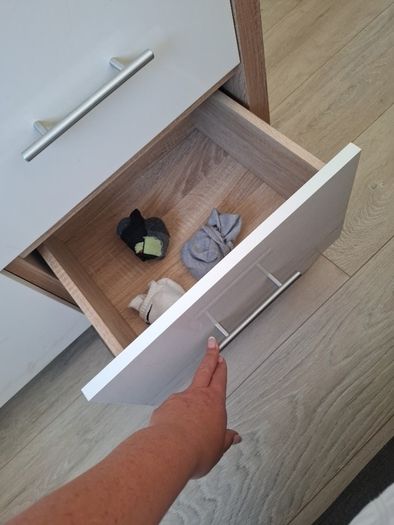Timer and white wardrobe and bedside locker