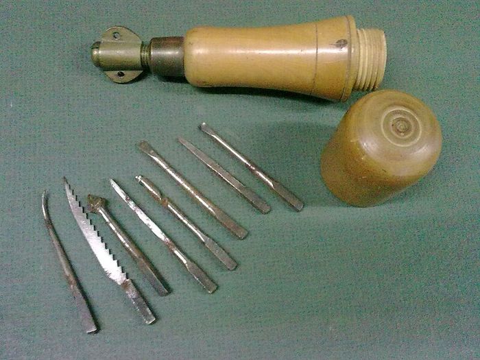 Old boxwood and brass tool pad with tools
