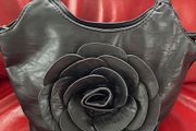 Handbag dressy occasional crossbody bag. Black Medium Size hand bag With Large Flora Feature . Detachable strap. Excellent Condition. Bought In Toulouse.