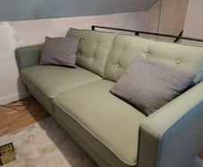 Green three seater sofa