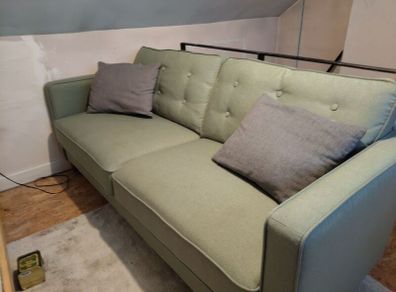 Green three seater sofa
