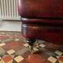 Leather Footstool on brass Castors. Image 3