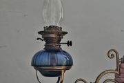 Victorian oil lamp on ornate brass sconce