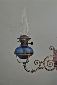 Victorian oil lamp on ornate brass sconce