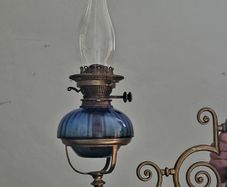 Victorian oil lamp on ornate brass sconce