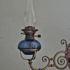 Victorian oil lamp on ornate brass sconce