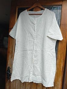 Off white linen button-down  longline tunic featuring a relaxed, oversized silhouette.