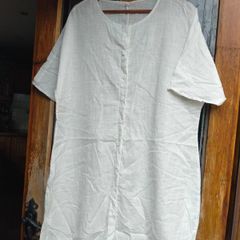Off white linen button-down  longline tunic featuring a relaxed, oversized silhouette.