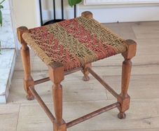 Antique wooden footstool with woven seat