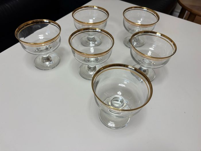 Set of six clear glass footed dessert dishes with gold-trimmed rims