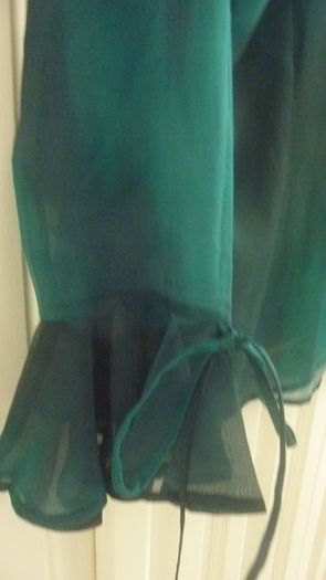 Green sheer blouse with tie-cuff detail