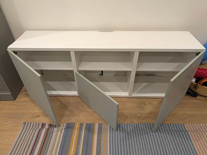 White TV unit with grey-green doors