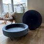 Large Round Blue Ottoman / Footstool with Storage  Stylish round ottoman with a dark denim-blue cushioned top, textured lighter blue base and black metal legs.  The top lifts off to reveal a handy storage space. Perfect as a footstool or styled with a tra Image 4