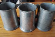 Three antique pewter glass bottomed mugs
