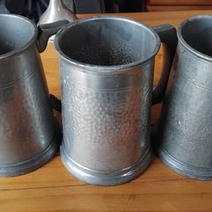 Three antique pewter glass bottomed mugs