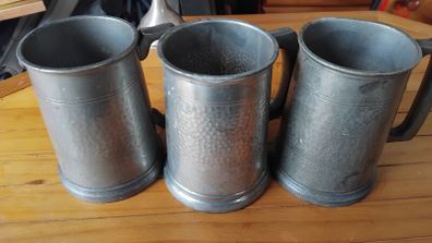 Three antique pewter glass bottomed mugs