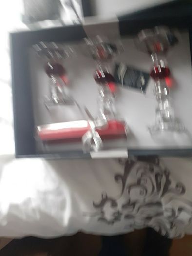 Newgrange candle holders new in box .20 euro .Would make a lovely christmas present .Glass with red and candles