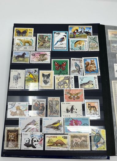 Ace Black 32 page/ 16 leaf Stamp Album with over 900 stamps. Thematic of Animals, Plants, Classic Cars, Space, Trains, Sport & Disney noted.