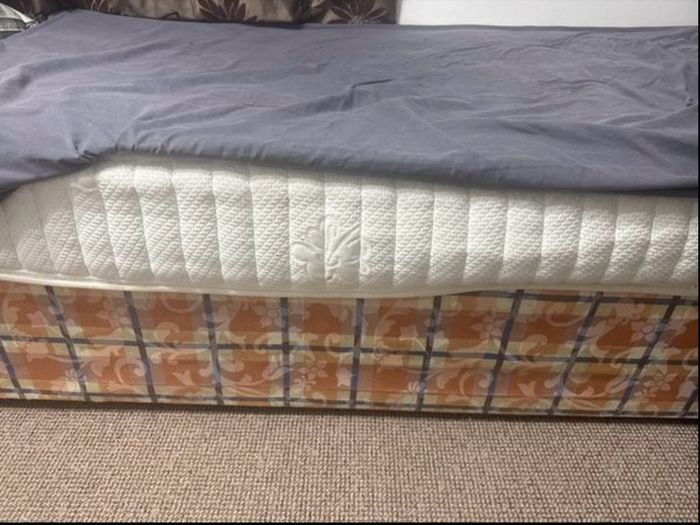 Single bed frame with headboard and mattress.