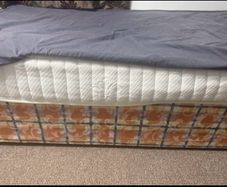 Single bed frame with headboard and mattress.