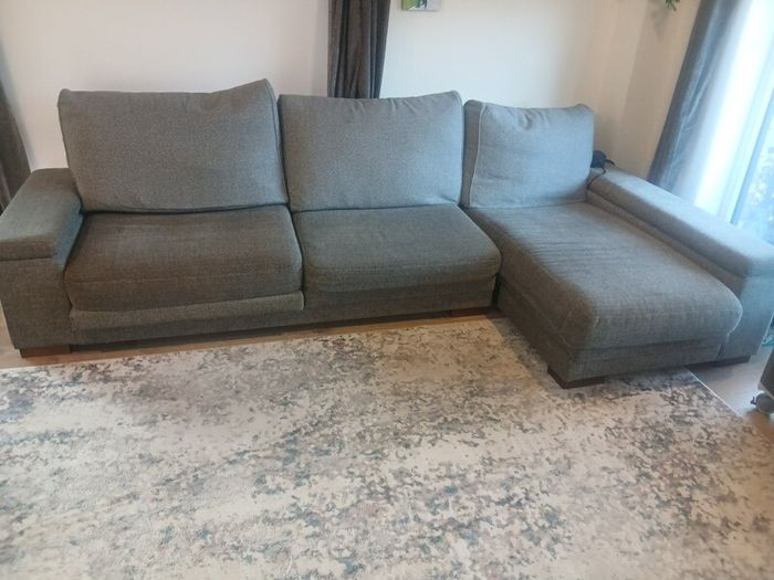 Grey L shaped corner sofa with 2 pouffes. Electric recline on long end