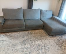 Grey L shaped corner sofa with 2 pouffes. Electric recline on long end