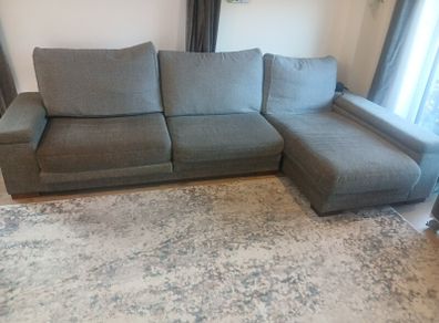 Grey L shaped corner sofa with 2 pouffes. Electric recline on long end