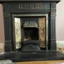 Late Victorian / early Edwardian style cast iron fireplace with tiled inserts and a decorative mantel surround Image 3