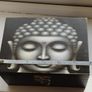 A wooden box with an image of the Buddha's head. Image 4