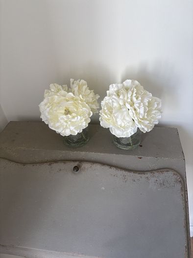 Pair of faux floral decorations with glass vases